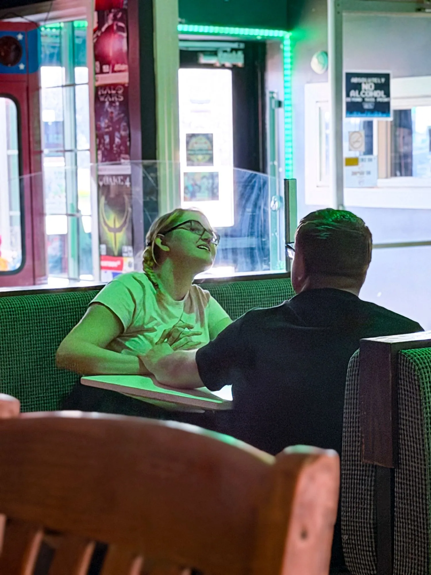 A couple sitting together in a window booth