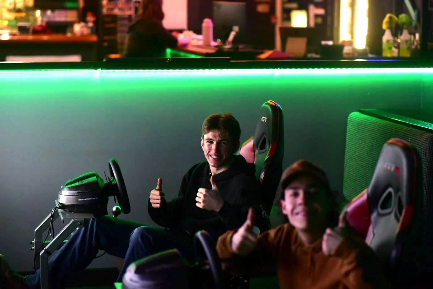 Two racers giving a thumbs up from the racing sims