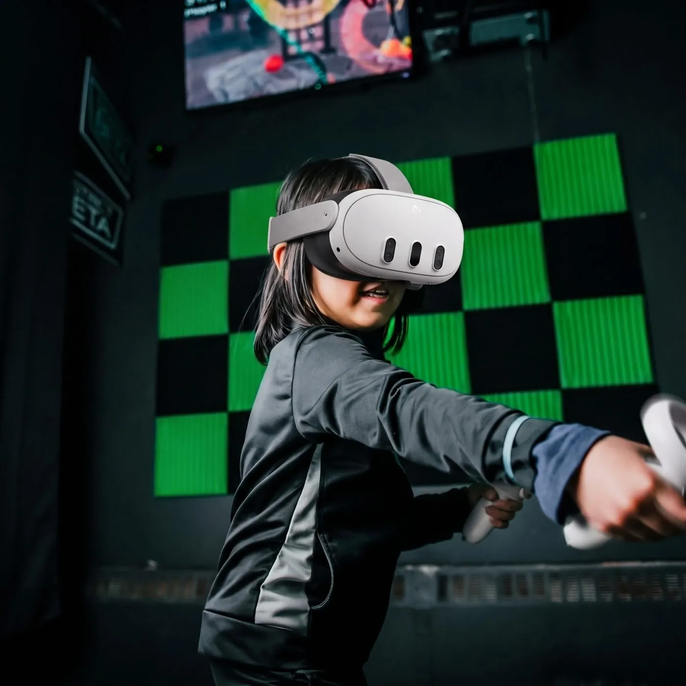 A kid in a VR headset reaching out mid-game