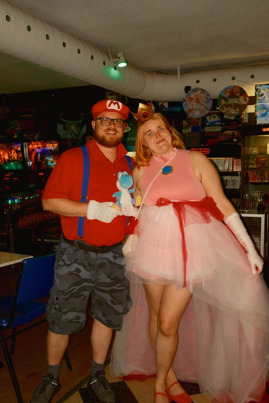Two guests dressed as Mario and Peach in the arcade