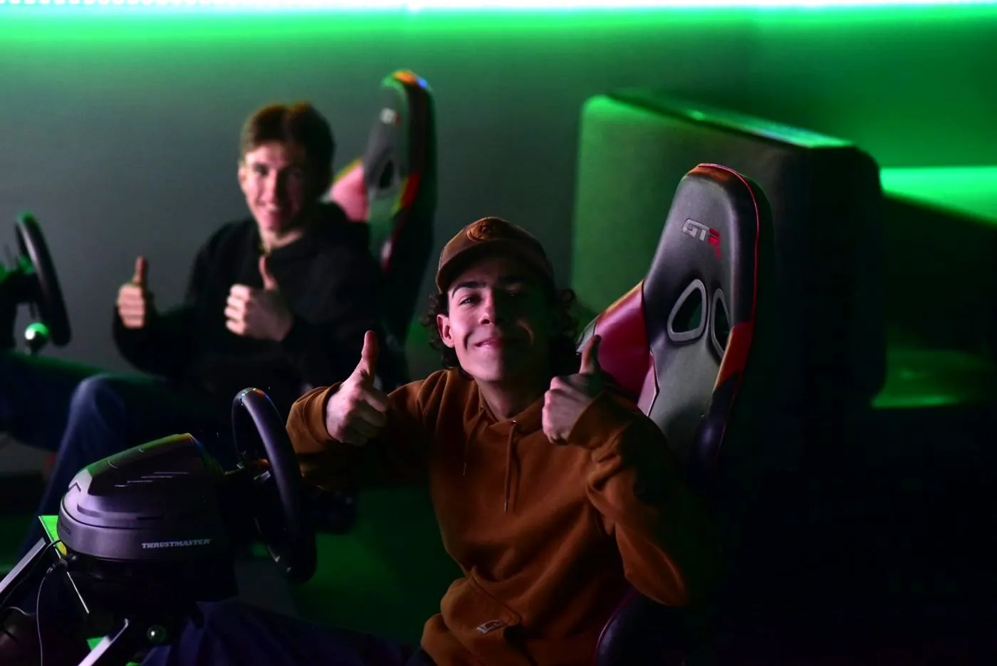 Two racers giving a thumbs up from the racing sims
