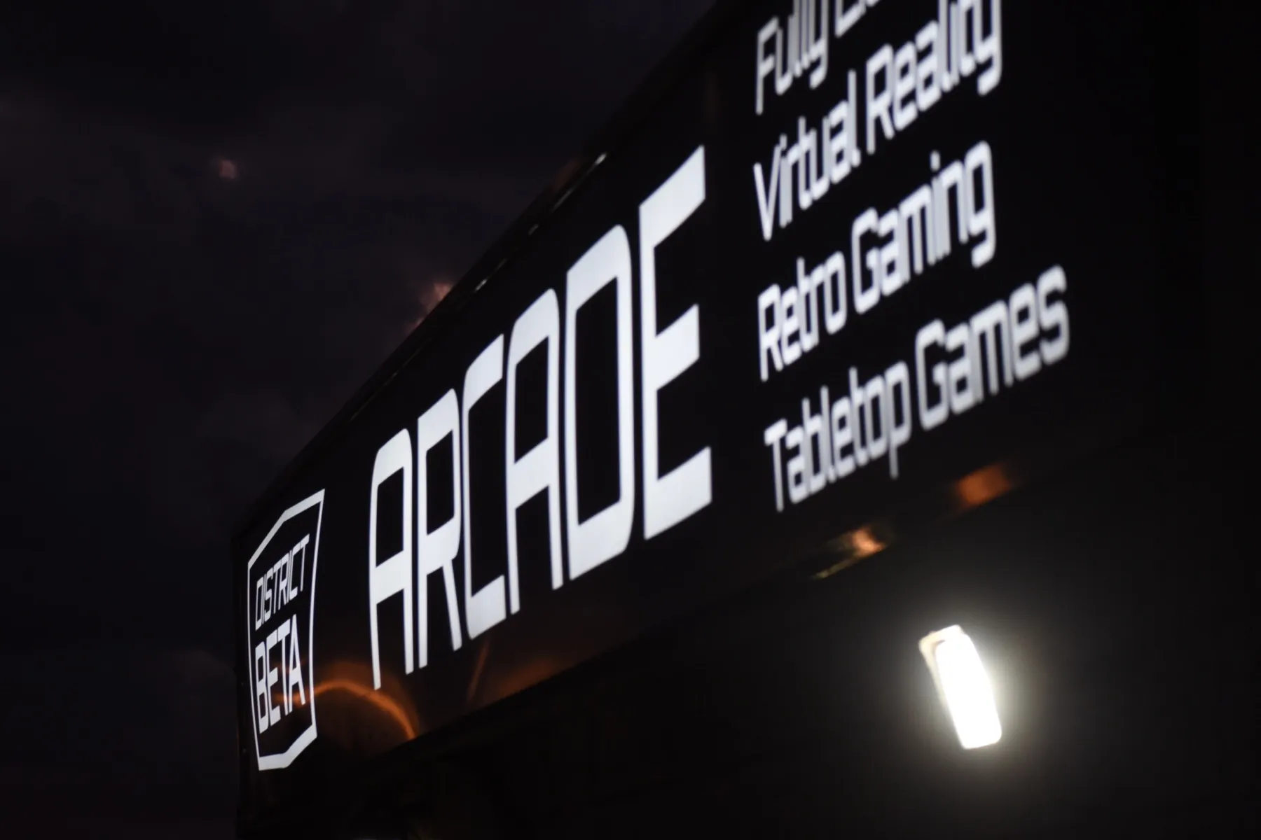The District Beta ARCADE sign at dusk