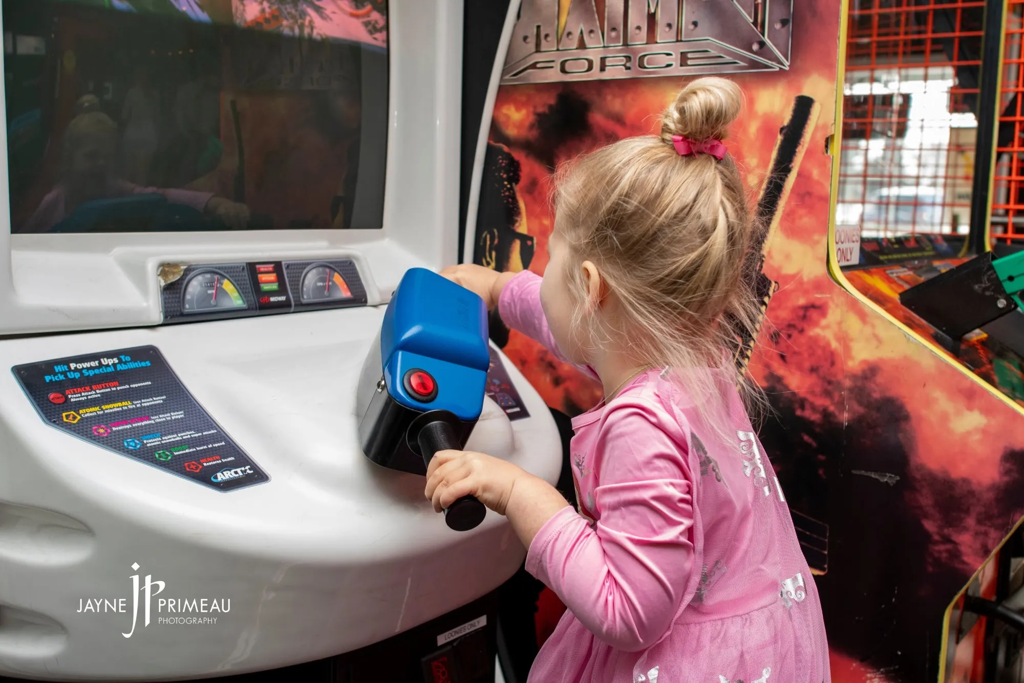 A girl steering an arcade cabinet