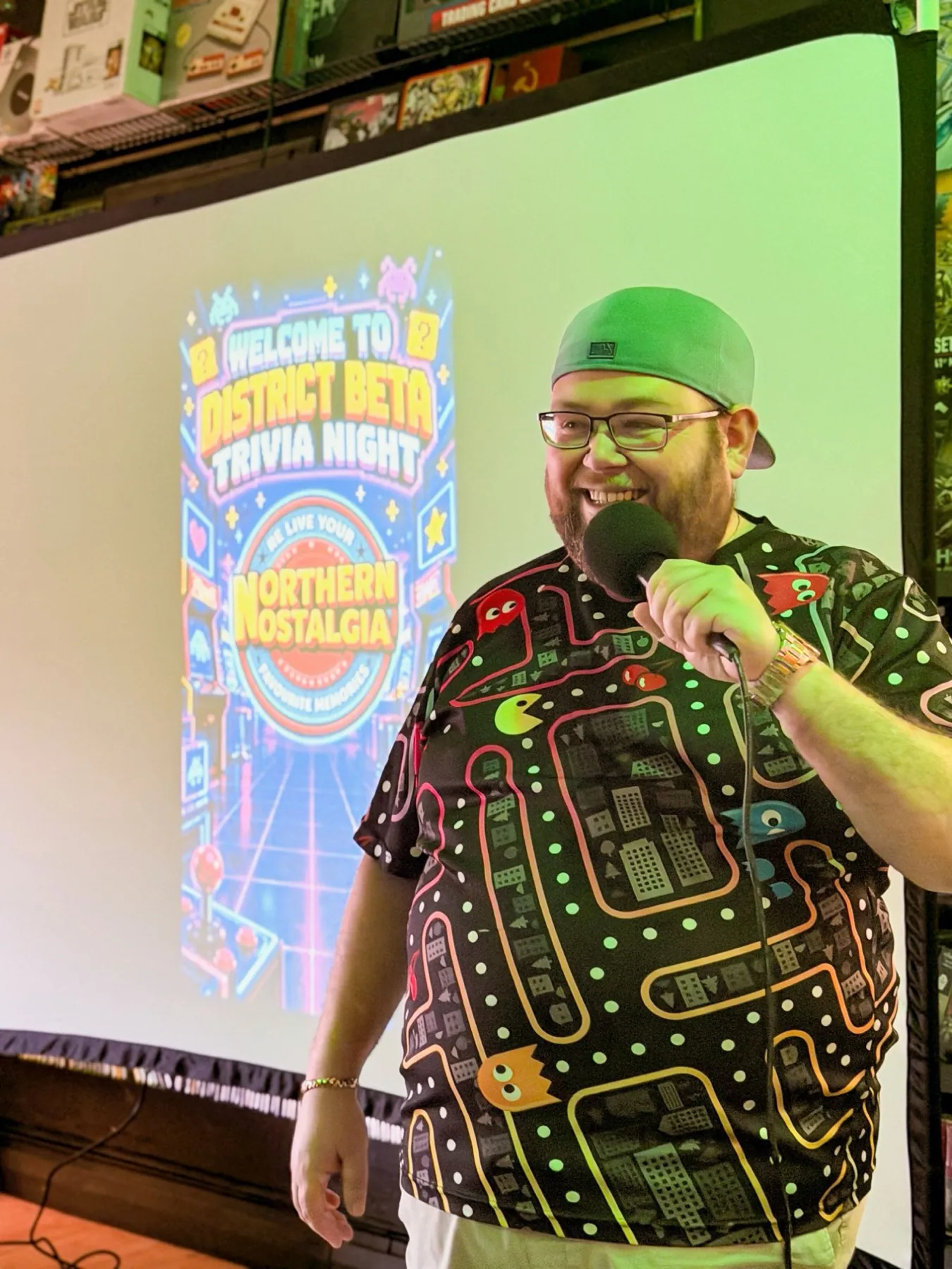 Our host with a microphone in front of the big screen