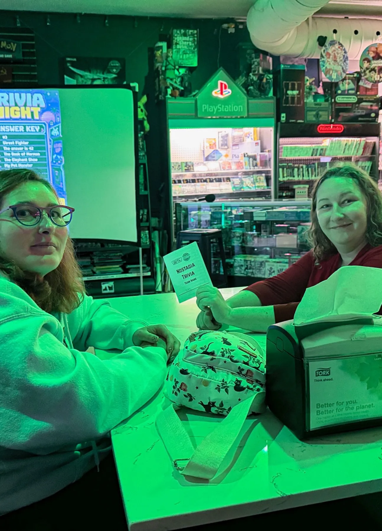 Two players with their trivia answer sheet